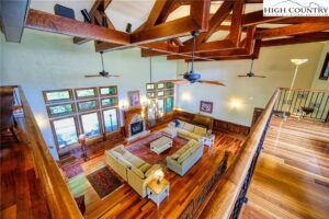 the interior of a beautiful home for sale in Ashe County with gorgeous hard wood floors and vaulted ceilings