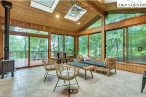 an open, airy rec room in an Ashe County home for sale with large windows and sky lights